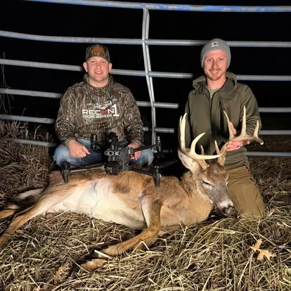 Recon1 pilot and hunter with a recovered buck at night, drone in hand